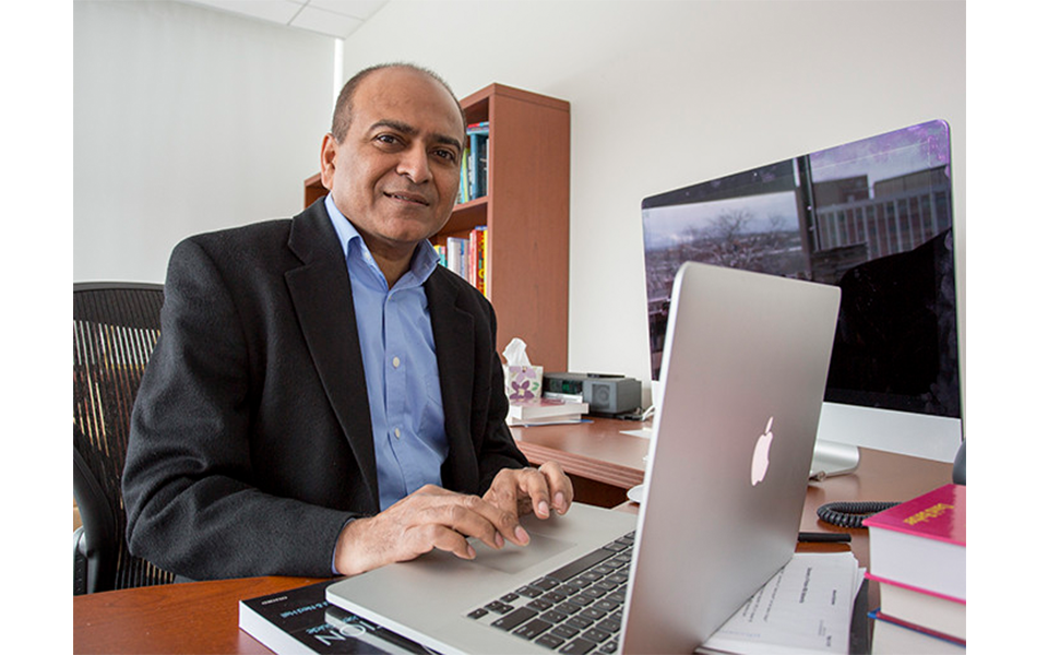 ICS Associate Director Vasant Honavar sits at his desk typing